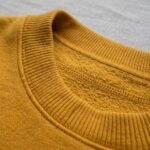 Detalle del cuello acanalado de la sudadera de Oshún amarilla