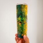 Termo de Oshún de 20 oz con diseño de Oshún con corona y vestido amarillo junto al río